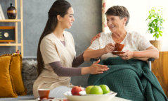 caregiver assisting a senior woman