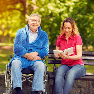 a woman sitting with a senior man 