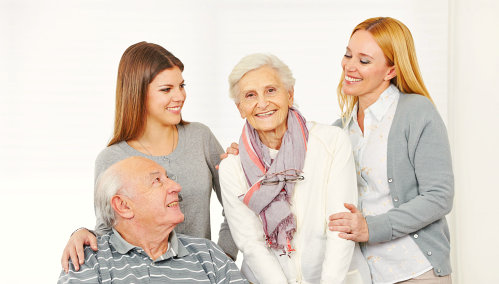 two woman with a senior couple