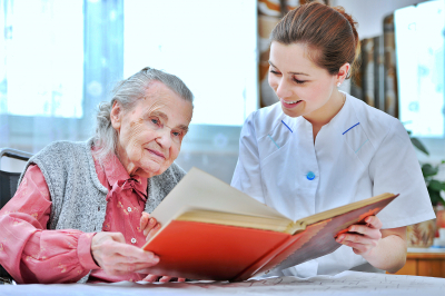 senior and caregiver reading