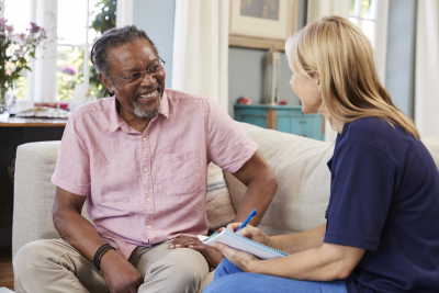 caregiver having a conversation with a senior man