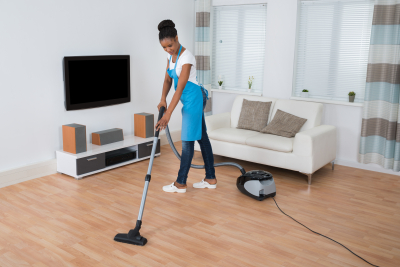 caregiver cleaning the living room